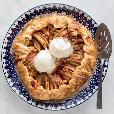 A homemade salted caramel apple galette topped with vanilla ice cream.の写真素材