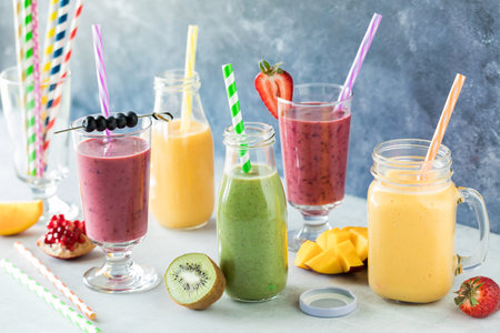 Delicious fruit smoothies surrounded by pieces of fresh fruit.の写真素材
