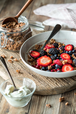 A healthy breakfast bowl with granola clusters and berries with greek yogurt.の写真素材