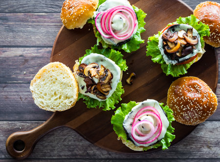 Top down view of portobello mushroom Swiss burgers with various toppings.の写真素材
