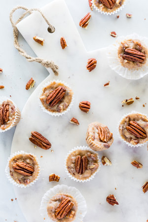 Salted caramel pecan fat bombs on a white marble board.の写真素材