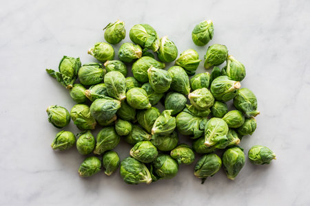 Top down view of a pile of fresh brussel sprouts, on a marble surface.の写真素材
