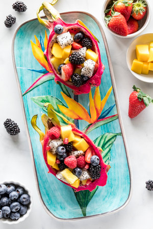Fresh Dragon Fruit salad bowls on a colourful tropical platter.の写真素材