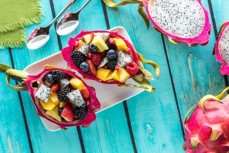 A platter of dragon fruit salad bowls on a bright turquoise background.の写真素材