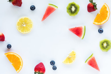 Fresh pieces of fruit scattered around with copy space in the middle.