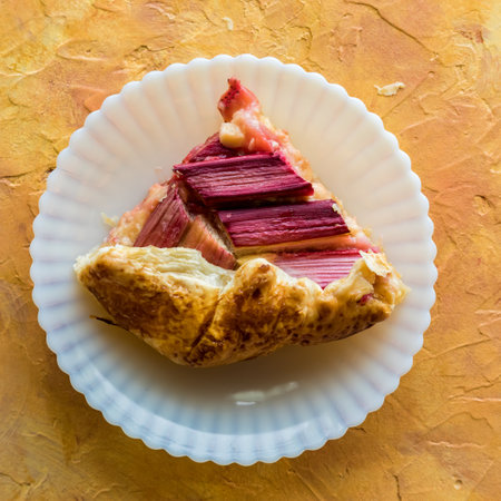 A slice of rhubarb and custard galette ready for eating.の写真素材