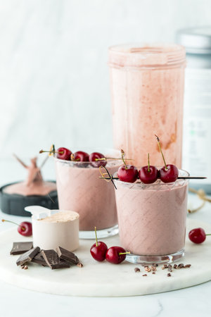 Chocolate cherry protein smoothie garnished with fresh cherries.の写真素材