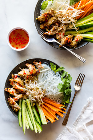 Vietnamese lemongrass chicken bowls with nuoc mam sauce.
