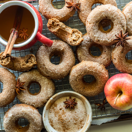 An arrangement of chia orchard doughnuts on a cooling rack with hot apple cider.の写真素材