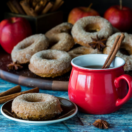 A sugar cinnamon coated doughnut with hot apple cider, ready for eating.の写真素材