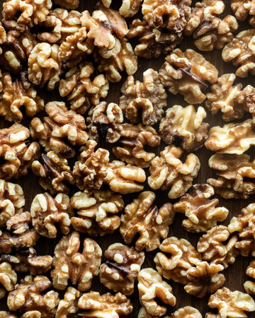 Top down close up view of a pile of walnuts.