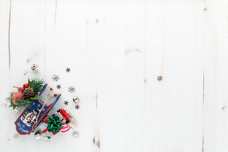 A small cluster of festive holiday decorations on a white rustic background.の写真素材
