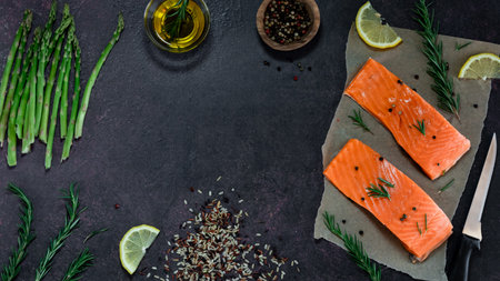 Fresh Coho salmon fillets with various other ingredients for preparing a meal.の写真素材