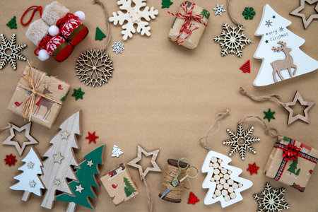 Wooden holiday decorations on brown paper with copy space in the middle.の写真素材