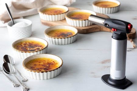 Pretty ramekins filled with delicious homemade Creme Brulee.の写真素材