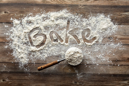 A baking concept background with flour on a wooden table.の写真素材