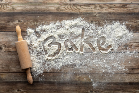 A baking background concept with flour and a rolling pin.の写真素材