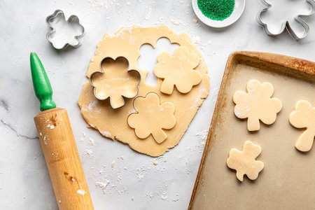 Sugar cookie dough rolled out to make shamrock cookies.