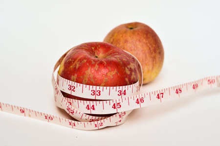 Red Apple Wth Measure Tape Isolate On White Background