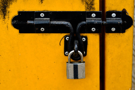 Black Bolt Lock On An Old Yellow Door