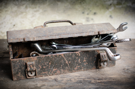 Old Tools Box with wrench on wooden deskの写真素材