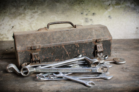 Old Tools Box with wrench on wooden desk