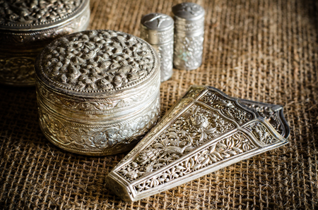 Ancient silverware on brown sackの写真素材