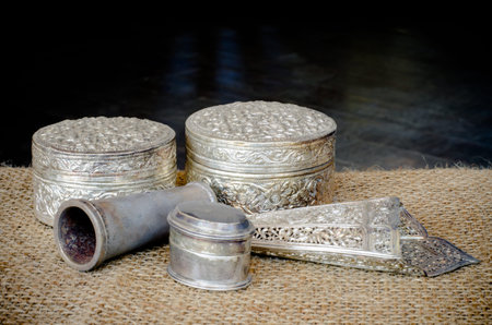 Ancient silverware on brown sack and dark wood floor backgroundの写真素材