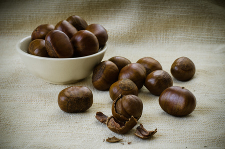 Dried Chestnuts on brown fabric の写真素材