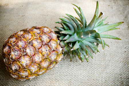 Pine apple on brownish sack の写真素材