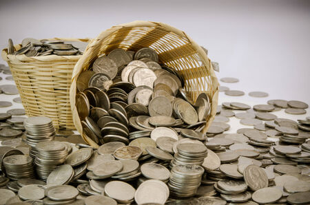Stack of Thai baht coins stock photo in bamboo bucketの写真素材