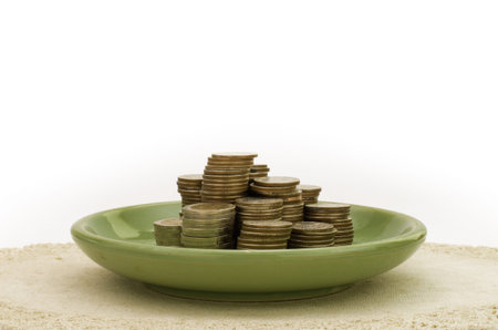 Stack of coin in green plate stock photoの写真素材