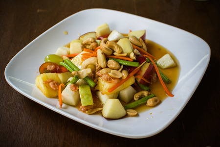 Thai spicy mixed fruit on white plateの写真素材