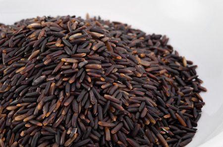 Organic black rice on white backgroundの写真素材