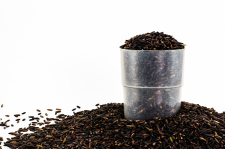 Organic black rice in plastic cup on white backgroundの写真素材