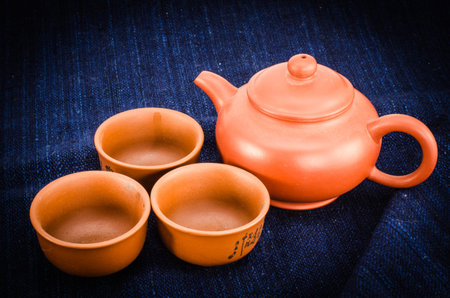 Brown tea set on deep blue fabricの写真素材