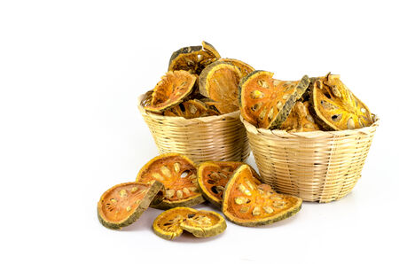 Dried quince in bamboo bucket on white backgroundの写真素材