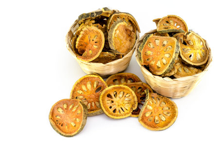 Dried quince in bamboo bucket on white background