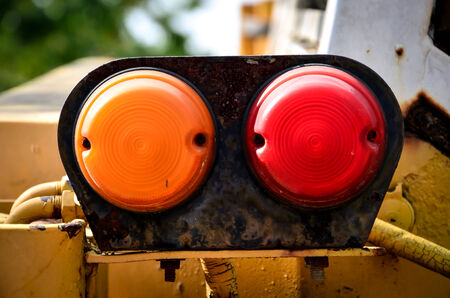Rear lamp of old yellow tractorの写真素材