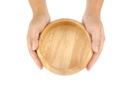 Woman's hands holding wooden bowl isolate on white backgroundの写真素材