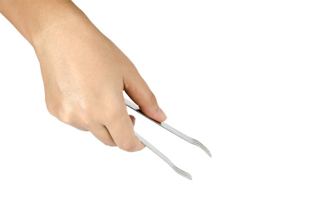 Woman's hand holding ice tongs isolate on white backgroundの写真素材