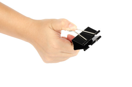 Woman's hand holding black paper clip isolate on white background