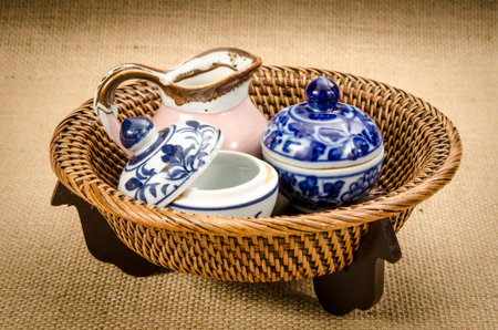 Image of old ceramic ware on bamboo woven trayの写真素材
