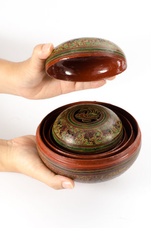 Image of hand holding wood casket isolate on white backgroundの写真素材