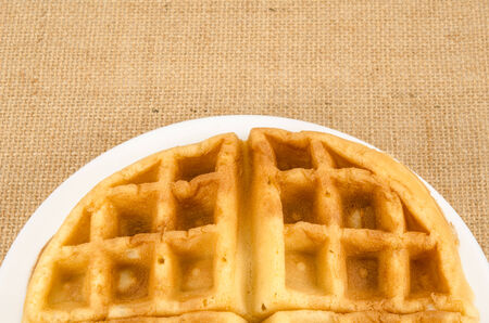 Image of waffle in white dish on brown sack backgroundの写真素材