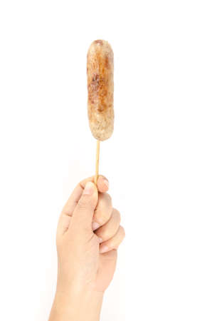 Grilled Thai rice and pork sausage holding by human handの写真素材