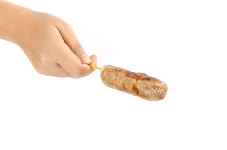 Grilled Thai rice and pork sausage holding by human handの写真素材
