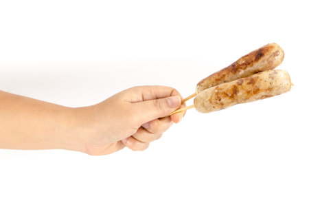 Grilled Thai rice and pork sausage holding by human handの写真素材