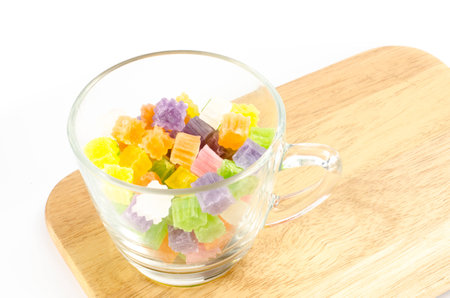 Image of Thai dessert in glass cup on wood cutting board on white backgroundの写真素材