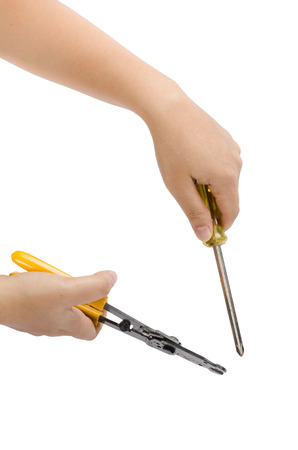 Image of hand holding cutting pliers and screw driver isolate on white backgroundの写真素材